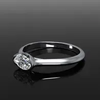 Silver ring with a clear oval gemstone on a dark gradient background