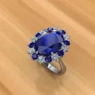 Blue gemstone ring with silver band on a wooden surface
