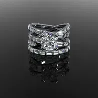 Silver diamond ring set on a glossy black surface, reflecting below.
