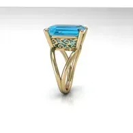 Gold ring with a blue rectangular gemstone and ornate openwork setting
