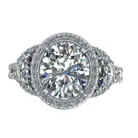Diamond engagement ring with a round center stone and halo setting on a white background