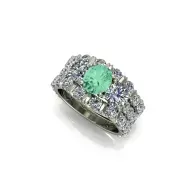 Silver ring with a green gemstone and clustered clear stones on a white background