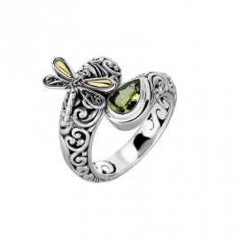 Silver ring with ornate scrollwork and a yellow-green gemstone, topped by a small dragonfly motif