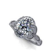 Silver diamond engagement ring with a halo setting and ornate band on a white background