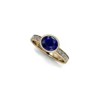 Gold ring with a round blue gemstone and small clear stones on a white background