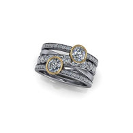 Silver and gold multi-band ring with two round diamond accents on a white background