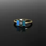 Gold ring with two dangling blue rectangular gemstones on a dark background