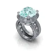 Silver ring with a large pale blue gemstone and ornate diamond-studded band on white background