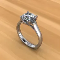 Silver solitaire diamond ring on a wooden surface