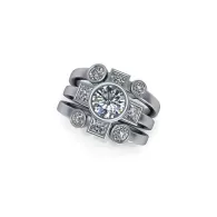 Silver ring with a round center stone and multiple smaller gemstones on stacked bands