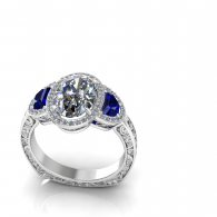 Silver engagement ring with oval diamond and two blue side stones
