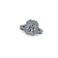 Silver engagement ring with a large center diamond and baguette side stones on a white background