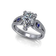 Silver jeweled ring with a large clear stone and blue accent gems on a white background