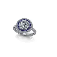 Silver ring with a round blue and clear gemstone halo setting on a white background
