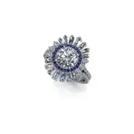 Silver ring with a blue center stone and clear halo stones on a white background