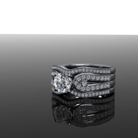 Diamond bridal ring set on a glossy black surface with a mirrored reflection