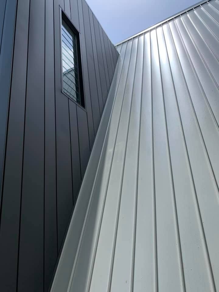 Modern Building Exterior, Grey and Silver Vertical Paneling — Over the Top Roofing Specialists in Narangba, QLD