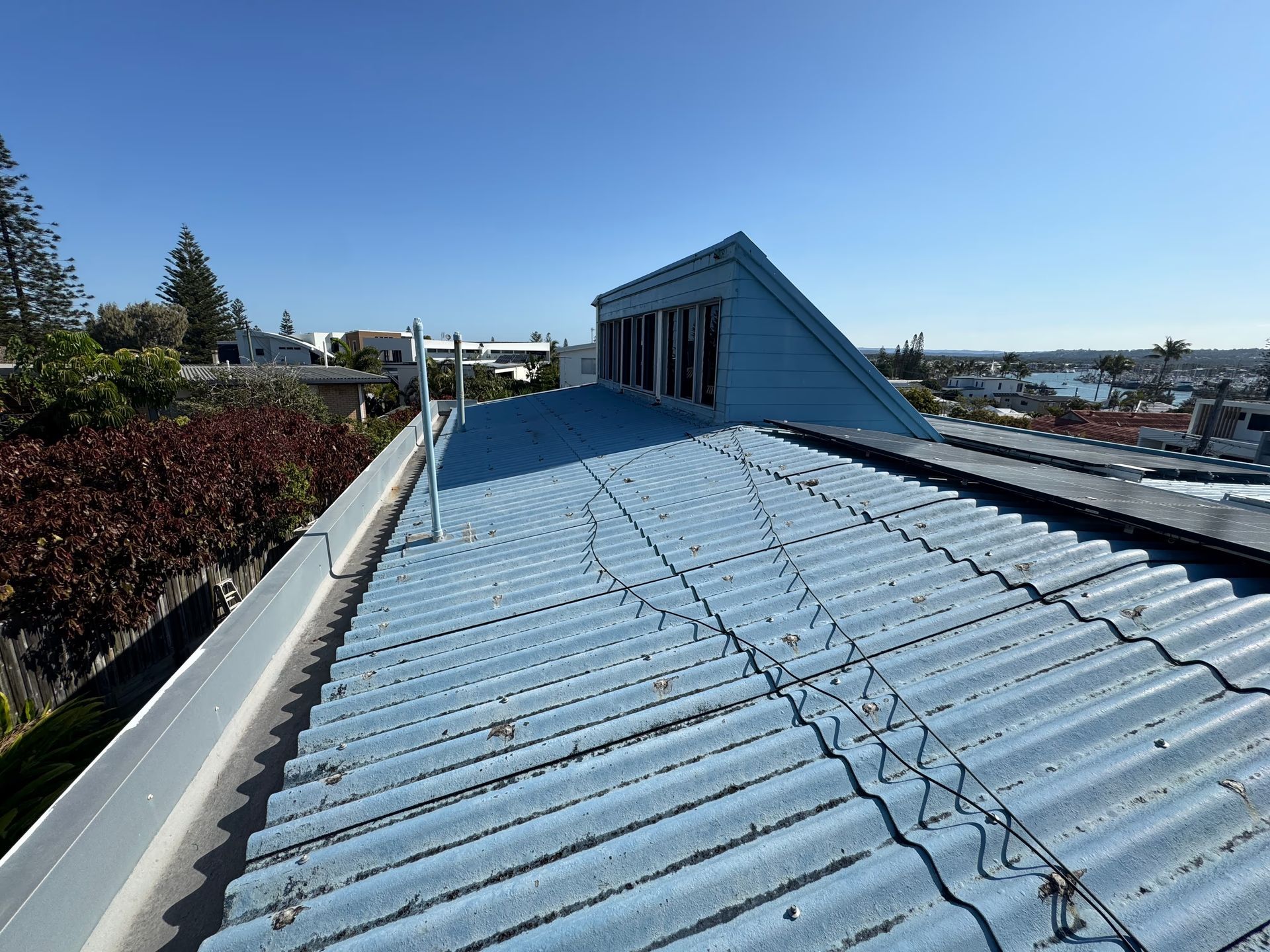 Blue Corrugated Metal Roof on a Building — Over the Top Roofing Specialists in Kunda Park, QLD