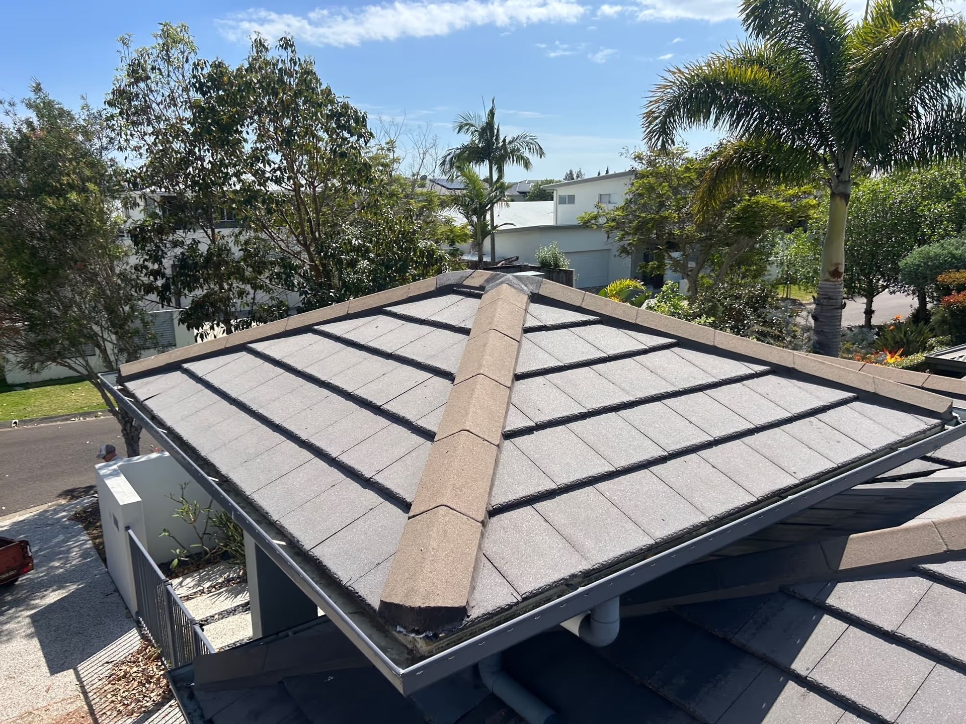 Gray Tiled Rooftop With a Brown Ridge — Over the Top Roofing Specialists in Kunda Park, QLD