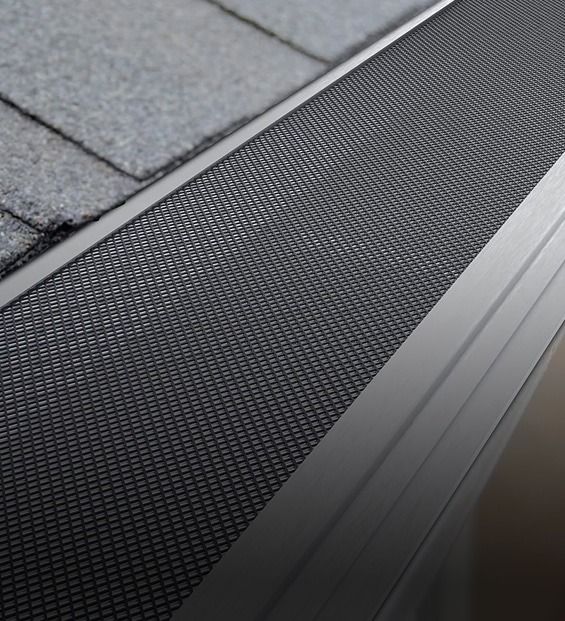 Close-up of a Gutter With a Black Mesh Gutter Guard — Over the Top Roofing Specialists in Kunda Park, QLD