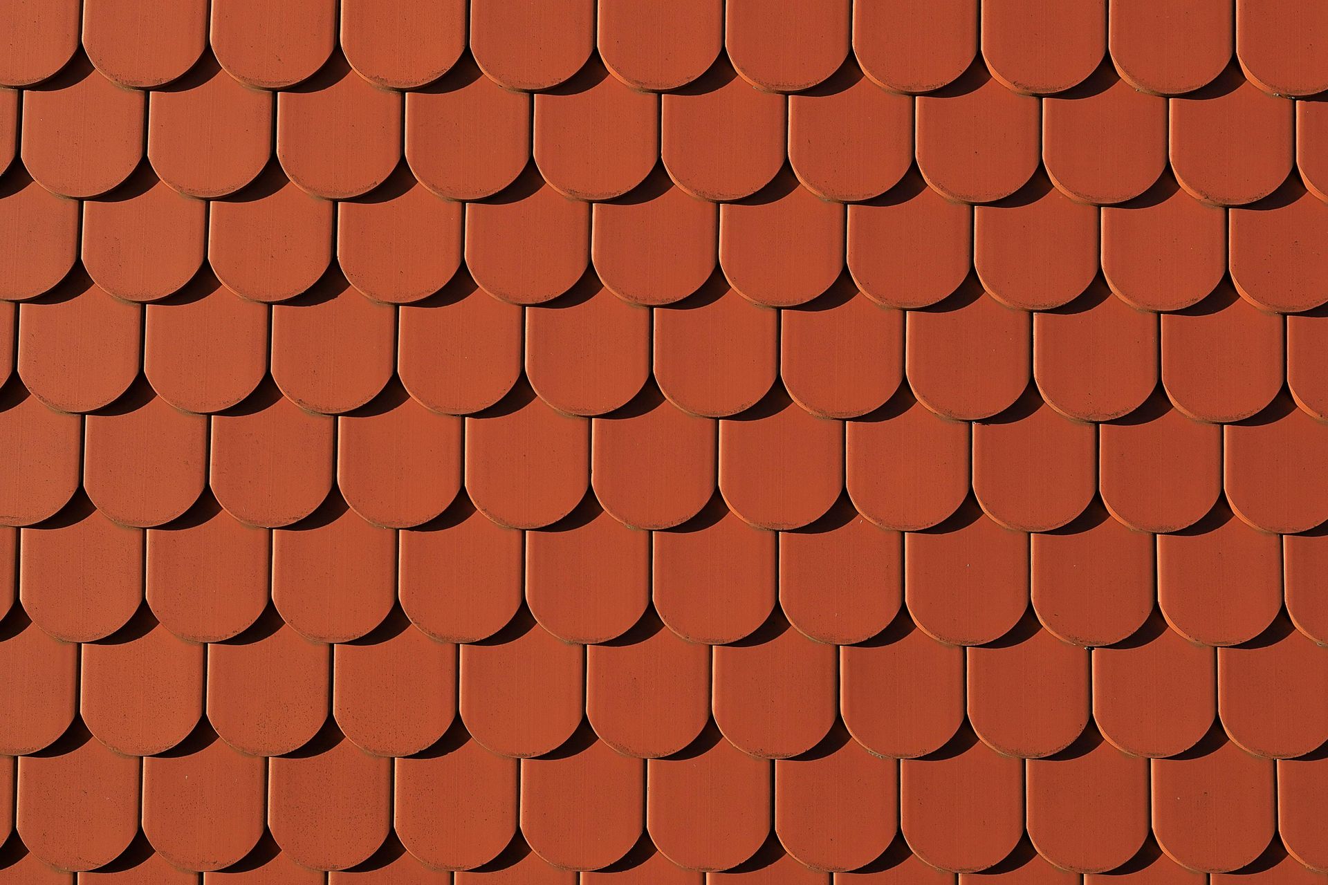 Red terracotta roof tiles arranged in overlapping rows