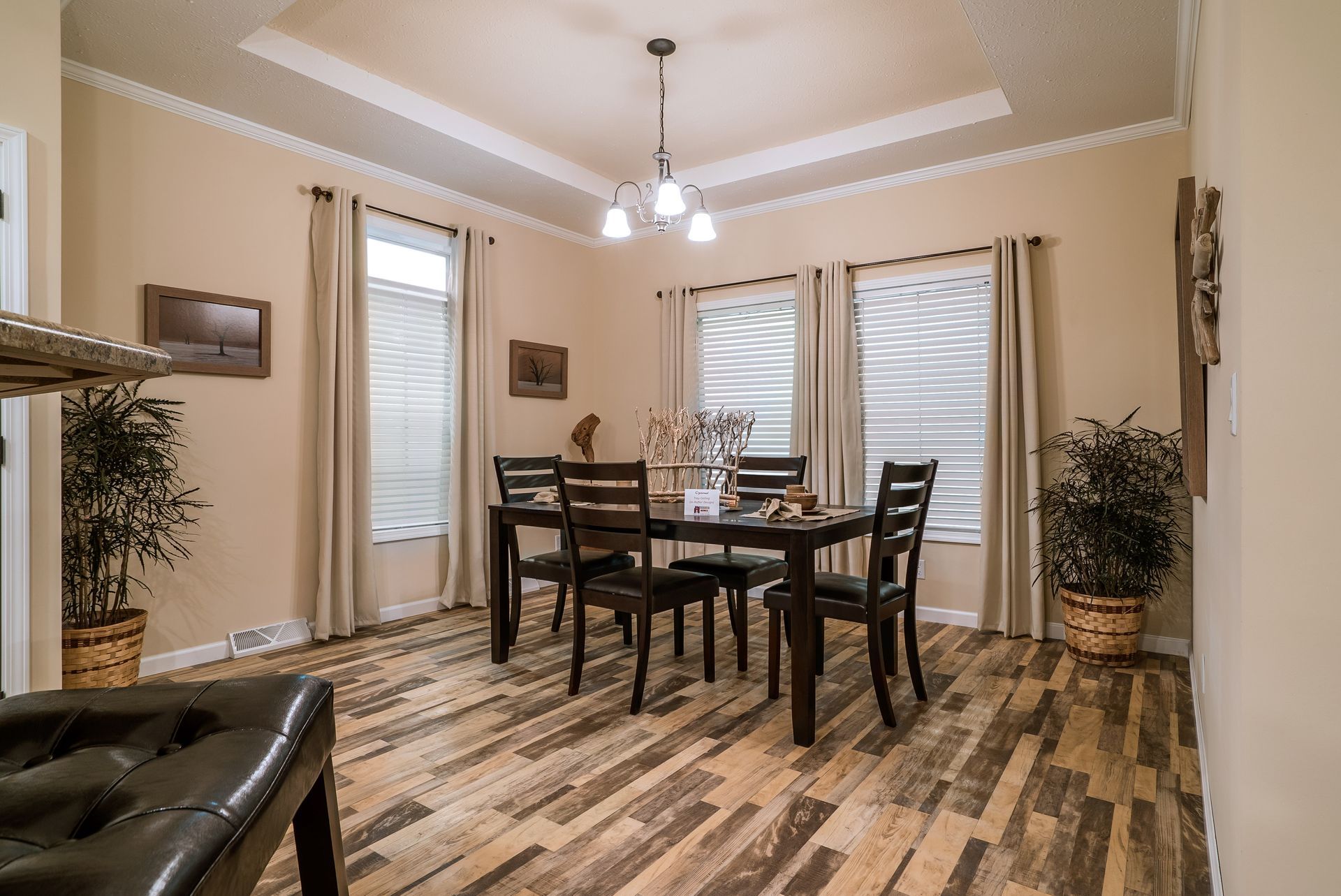 a dining room with a table and chairs and a wooden floor .