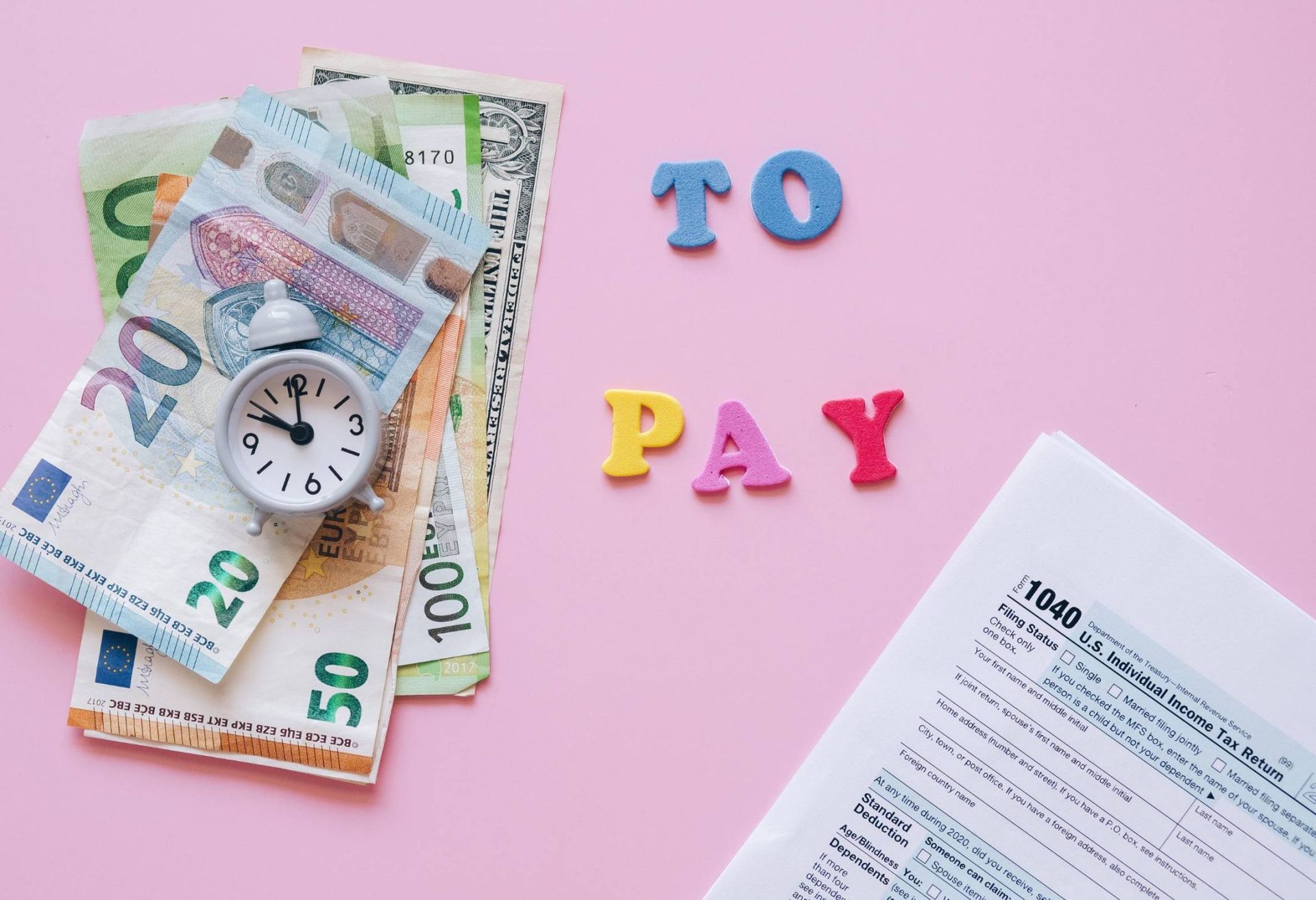 Cash and a clock beside “TO PAY” on a pink background, with a bill document partially visible.