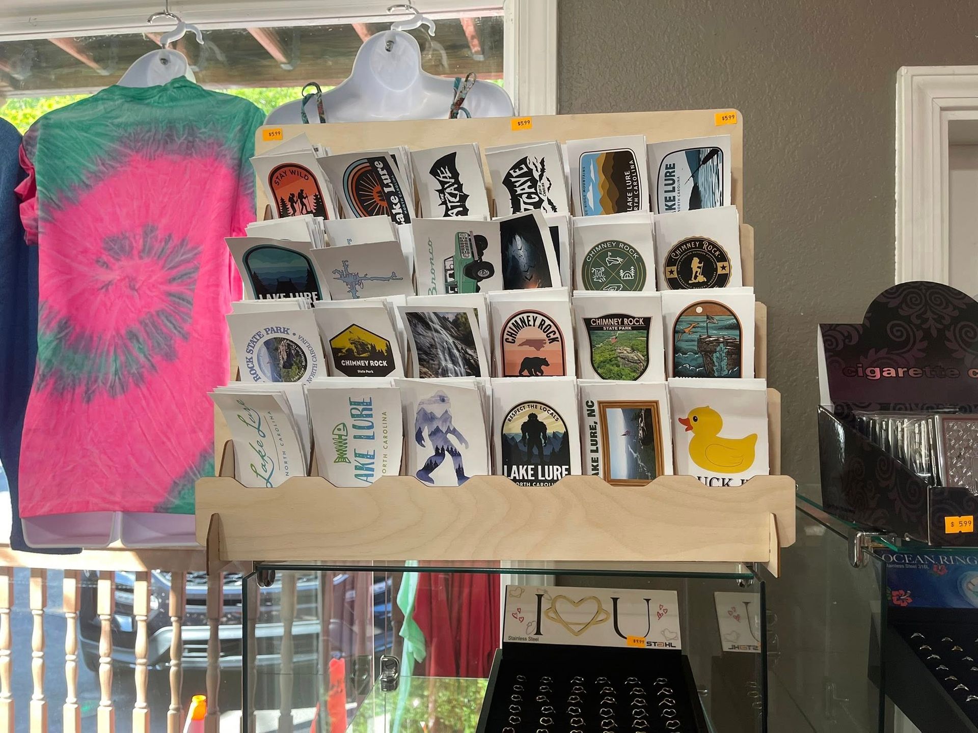 Assorted souvenirs, shirts, and accessories in a welcoming mountain shop display.