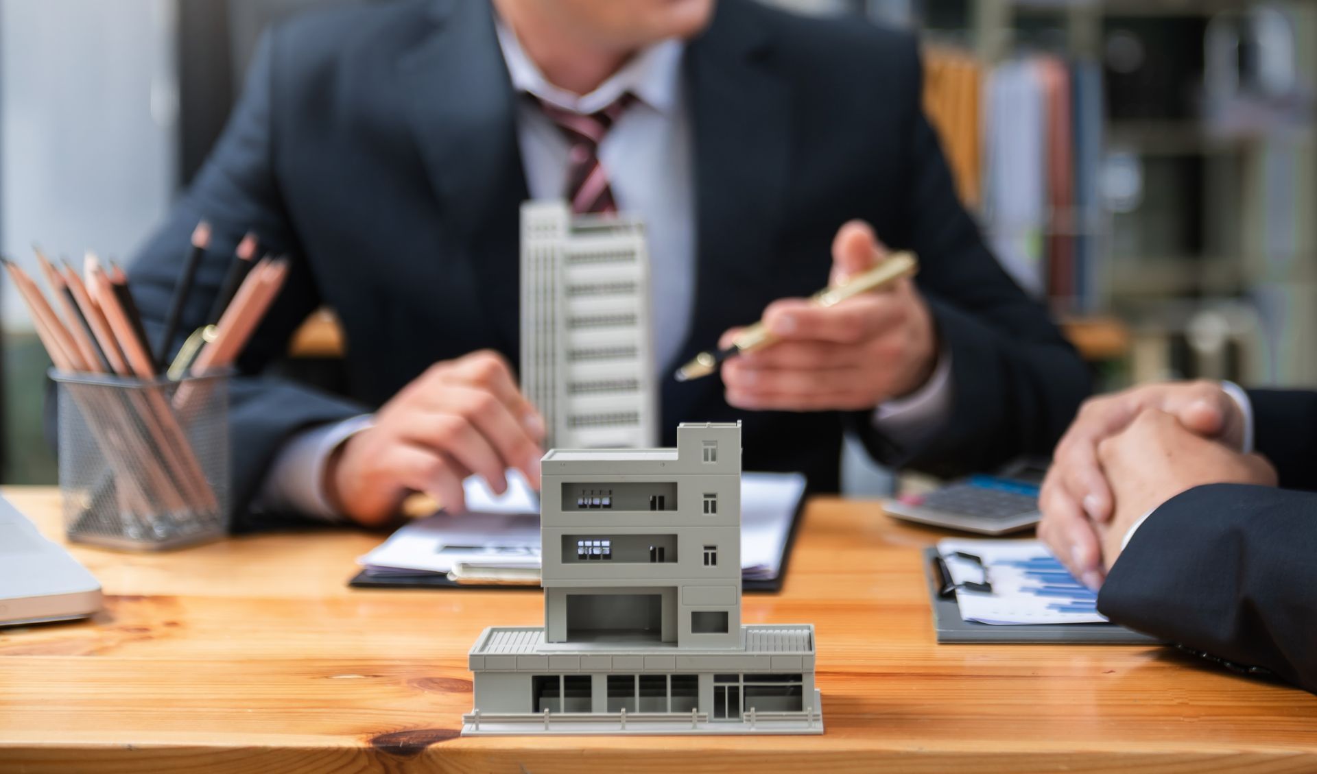 Model building on a desk during a business meeting