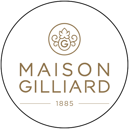 Le logo de la maison gillard est un cercle avec une feuille dessus.