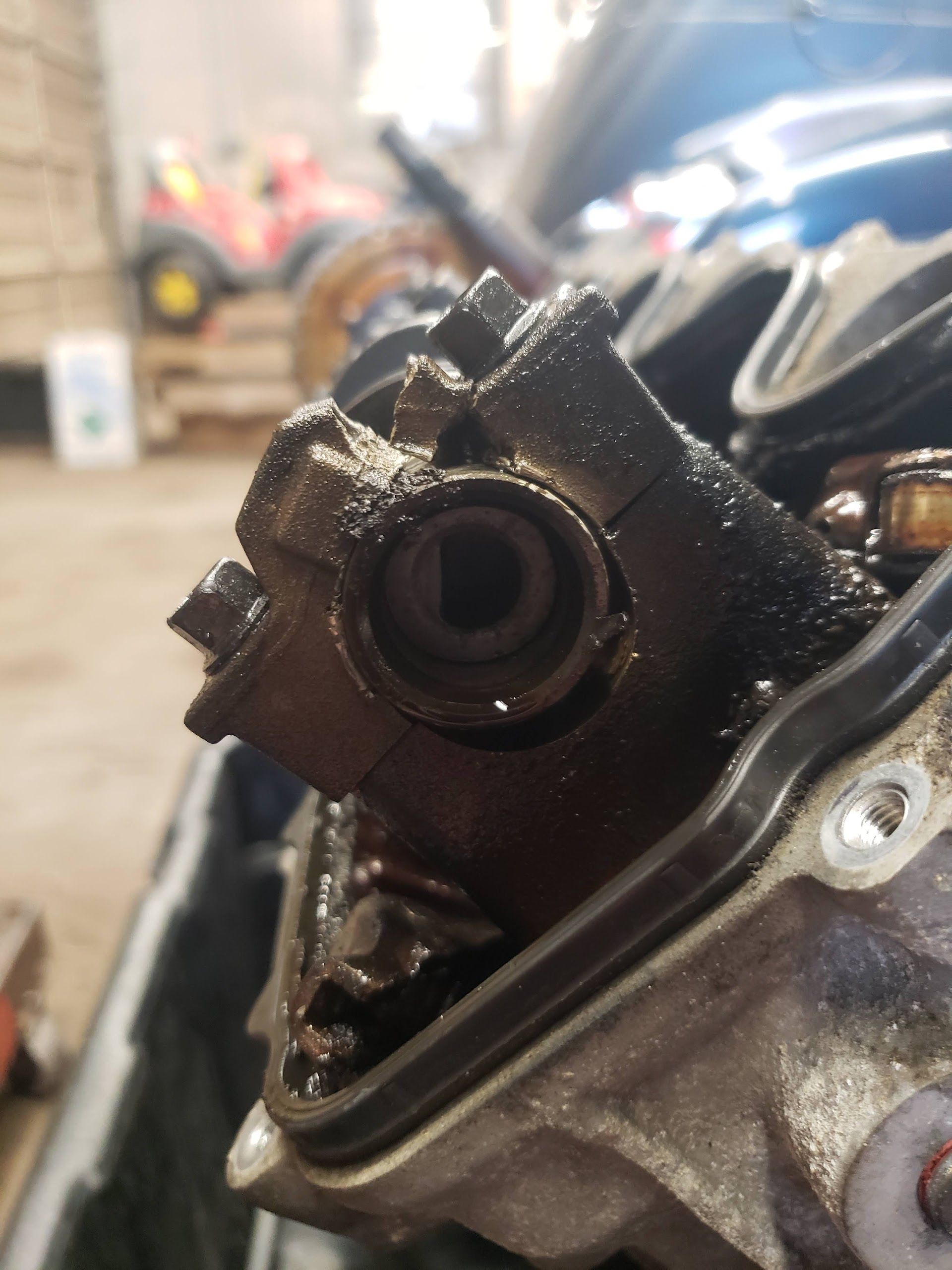 Close-up of a car engine part covered in oil | Gateway Automotive Inc.