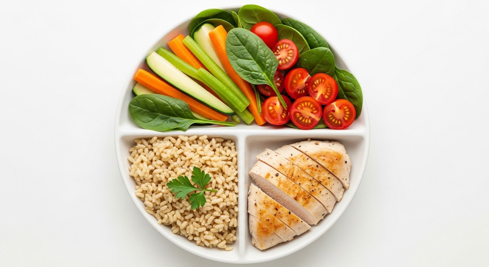 Plate with grilled chicken, brown rice, and assorted raw vegetables.