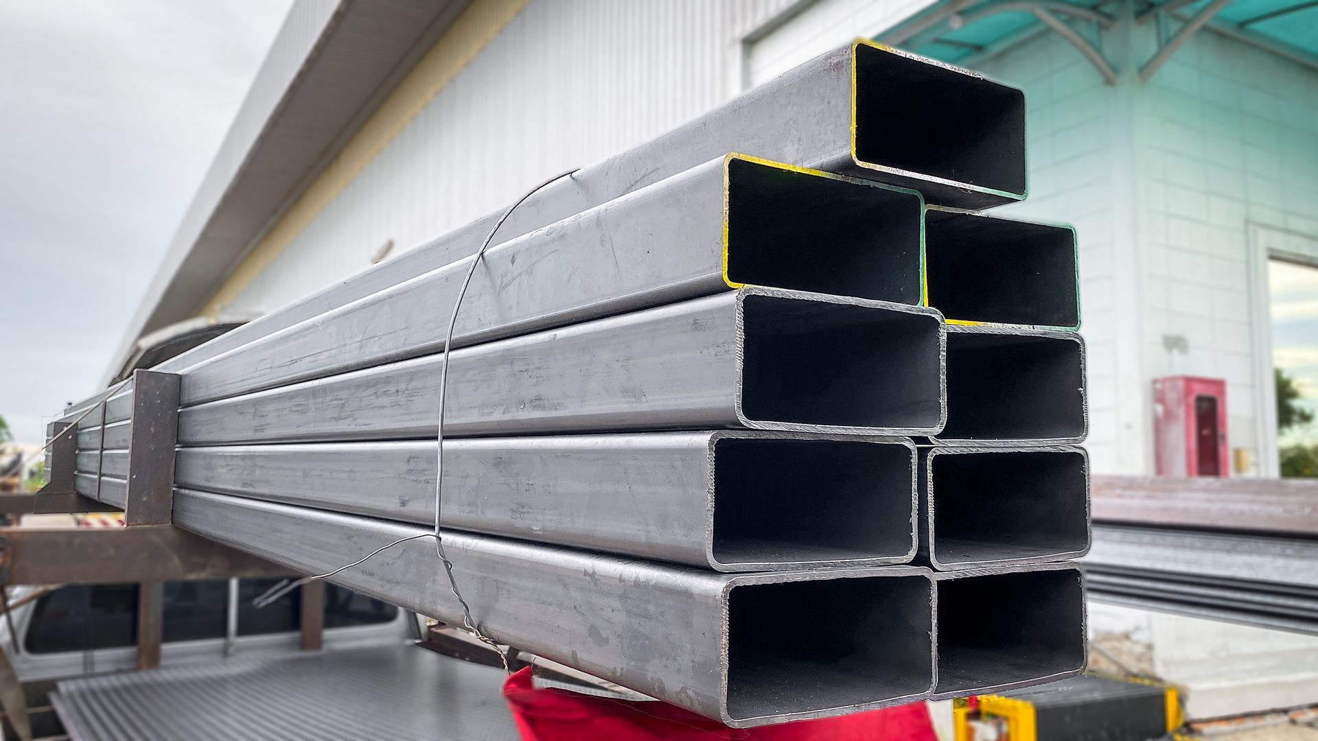 Stacked rectangular steel tubing bundled and ready for delivery. Stacked rectangular steel tubing bundled and ready for delivery.
