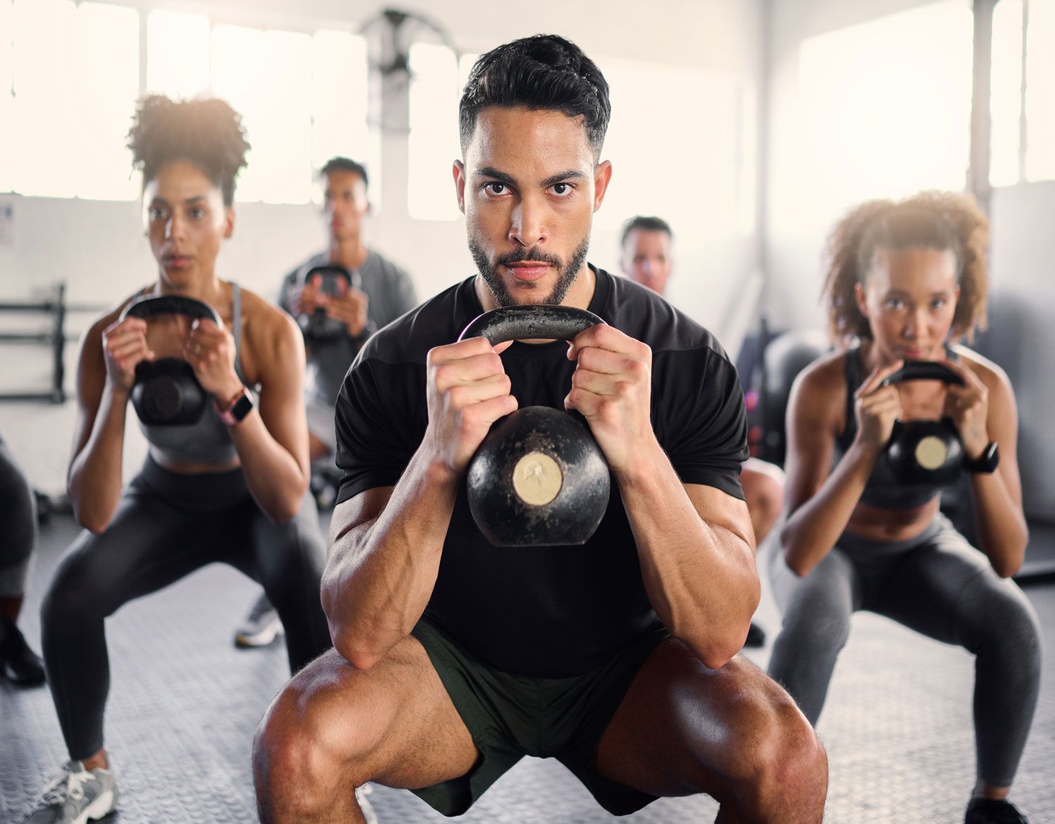 kettlebell-workout-and-fitness-class-with-a-gym-coach-and-people-training-with-cardio-and-exercise