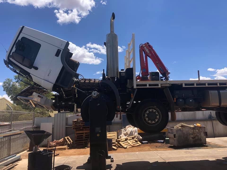 A Truck With the Hood Up is Parked in a Parking Lot — RK Diesel Services in Ciccone, NT