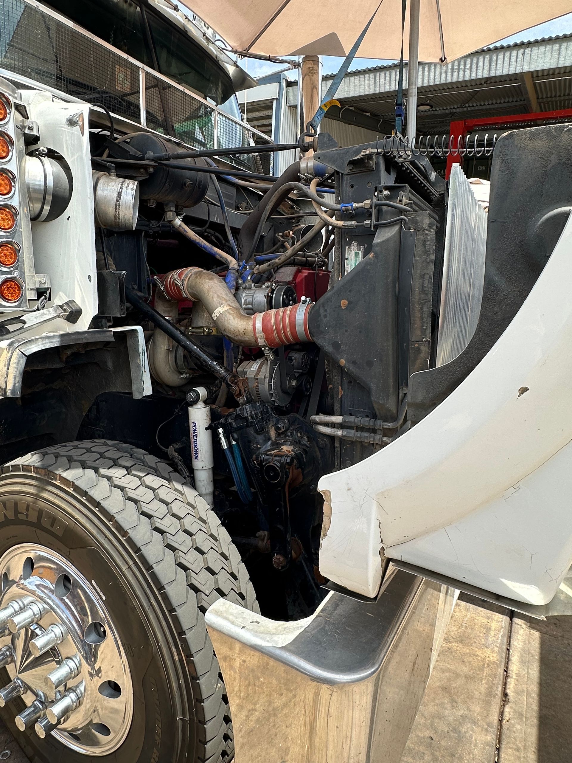 Open hood of a semi-truck revealing the engine. Engine components are visible. — RK Diesel Services in Ciccone, NT