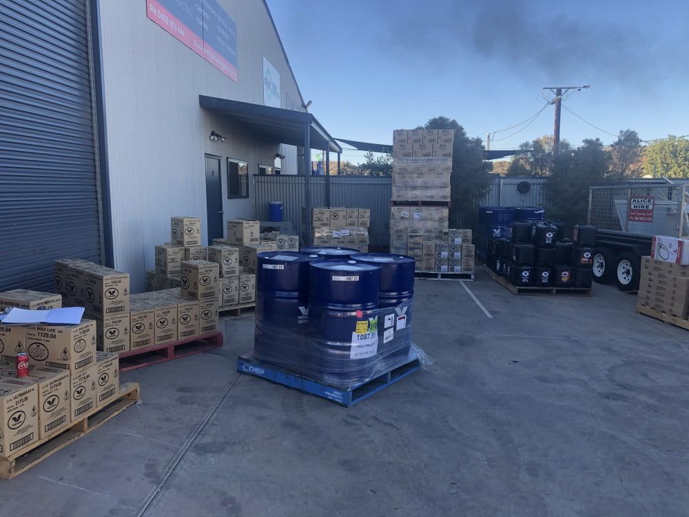 A Warehouse Filled With Lots of Barrels and Boxes — RK Diesel Services in Ciccone, NT