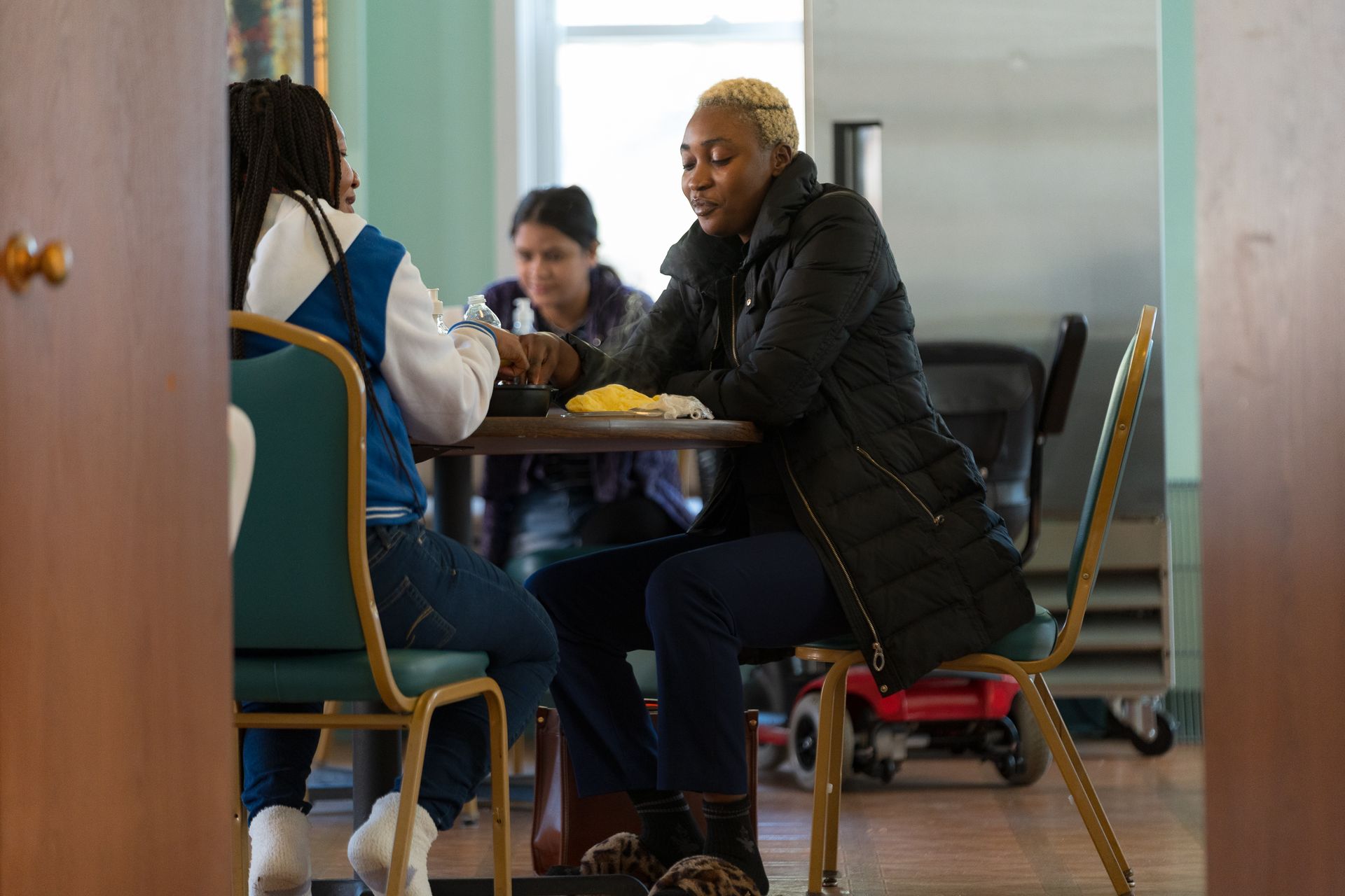 Clients and staff share lunch at AWE between Day Program classes. Photo credit: Wide Angle Media