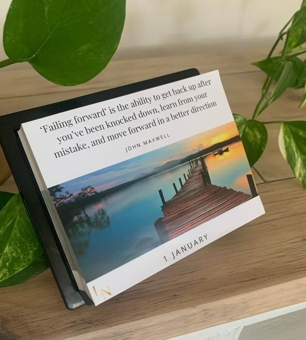 A calendar with a picture of a dock and a quote on it