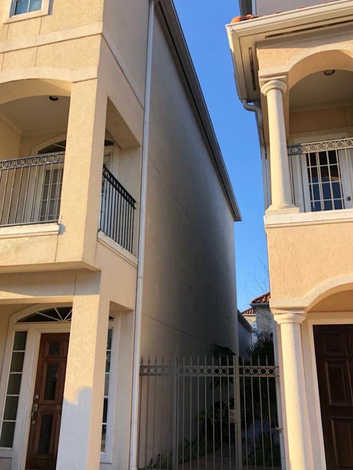Two houses are next to each other with a fence between them