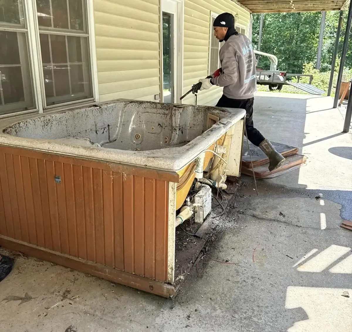 Travon of Junkstar Services removing an old hot tub