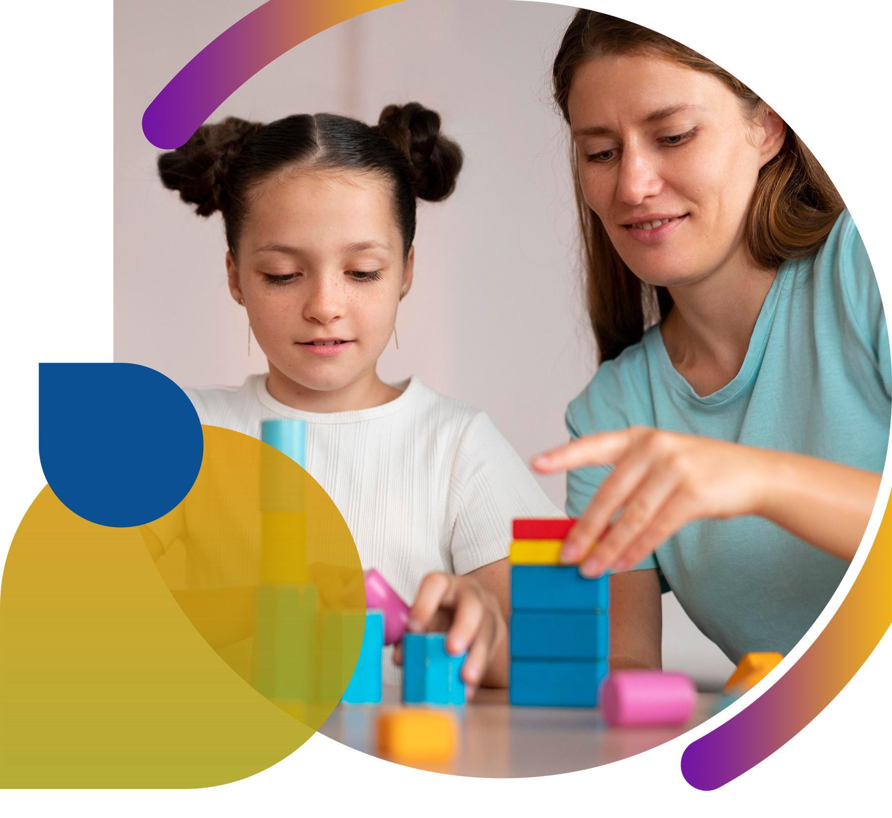 A woman and a little girl are playing with blocks at a table.