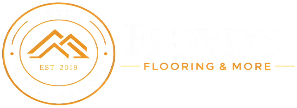 Orange circular logo with mountains and &ldquo;EST 2019&rdquo; beside the text &ldquo;FLOORING & MORE&rdquo;