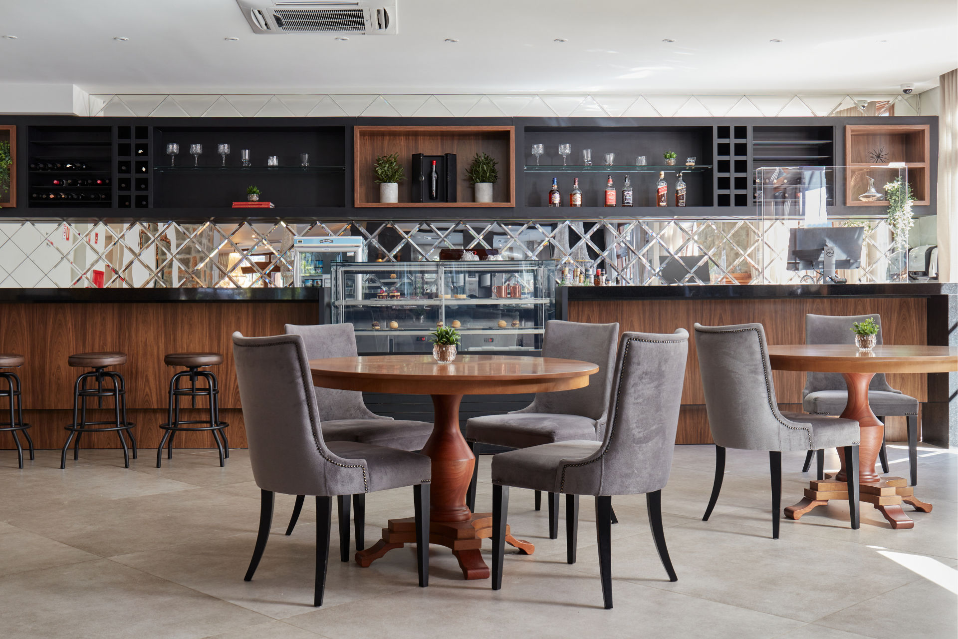 Um restaurante com mesas e cadeiras e um bar.