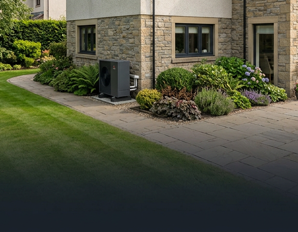Air source heat pump installed beside a Scottish stone home