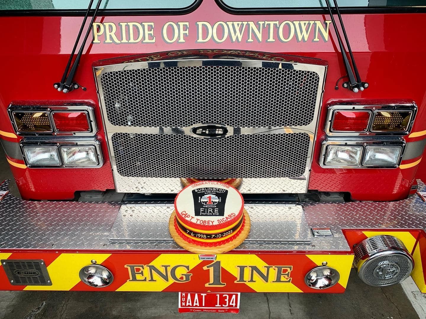Fire truck with a cake on its bumper.