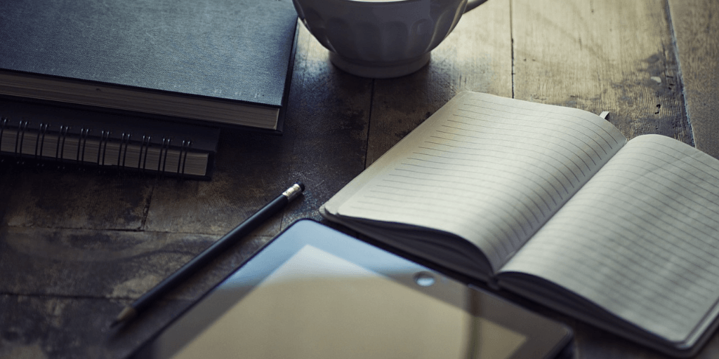Pad of paper, tablet and a pencil to write a blog