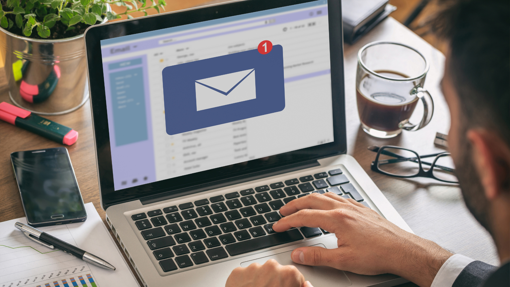 A person opening their email on a laptop.