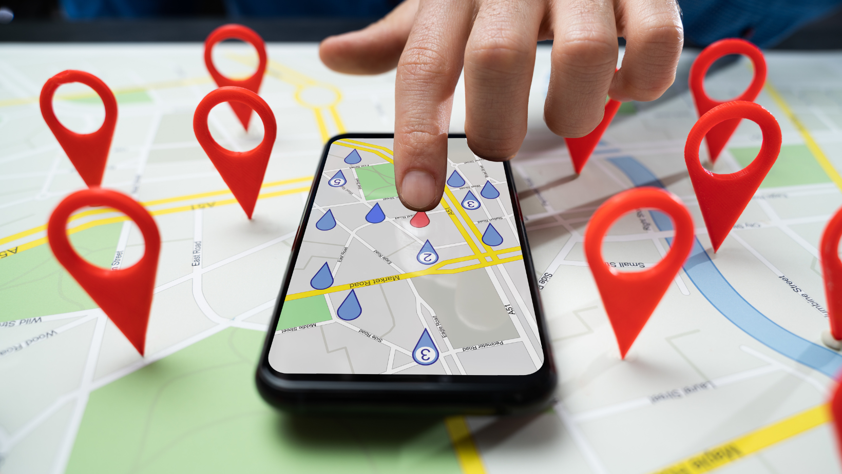 Someone selecting a pinned location on a digital map on a phone.