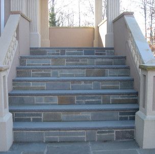 A set of stone stairs leading up to a porch